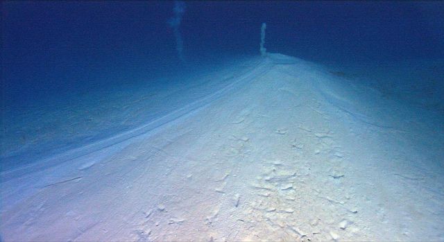 Mud volcano caused by methane gas bubbling up through the sea floor with a resultant small cone that looks similar to a lava producing volcano Picture