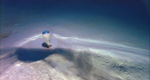 A large bubble of methane gas emanating upward from the crater of a mud volcano. Picture