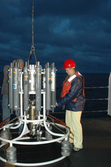 Oceanographer Liz Zele prepares to deploy the CTD from the deck of the NOAA Ship McARTHUR II with the help of technician Lacey O'Neal. Picture