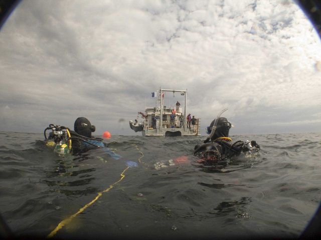 Divers Benjamin Cowie-Haskell and Deborah Marx wait to be picked by the R/V Auk after a dive to the shipwreck of the coal schooner Paul Palmer Picture