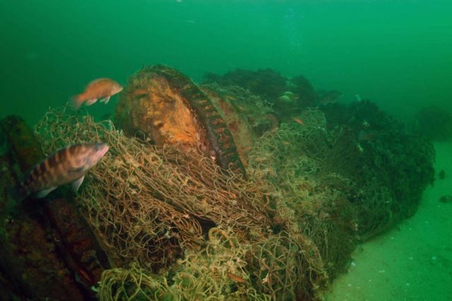 A large trawl net was wrapped around the windlass on the shipwreck of the coal schooner Paul Palmer until it was removed by NOAA divers in 2006. Picture