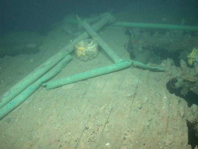A ceramic mug sits amongst twisted pipes on the steamship Portland's main deck Picture