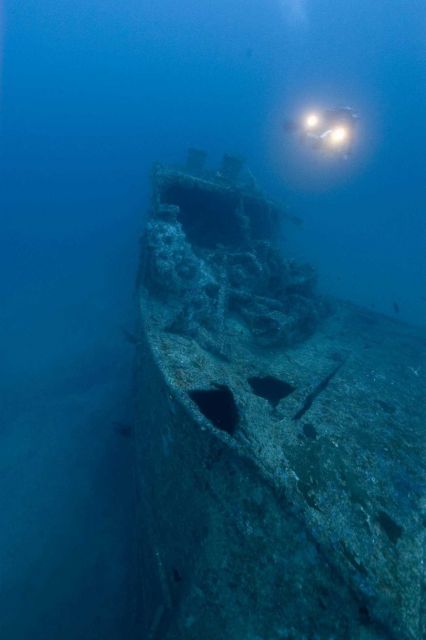 Diver with lights approaching the bow of the NORTHERN LIGHT, a shipwreck in 190 feet water depth Picture