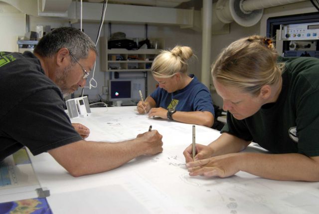 The Maritime Heritage Program Team tranferring measurements obtained on shipwreck site to a map of the area Picture