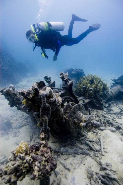 Diver investigates the anchor windlass at the OSHIMA shipwreck site. Picture