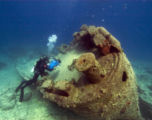 NOAA diver John Brooks inspecting the remains of the USS MACAW at Midway Island. Picture