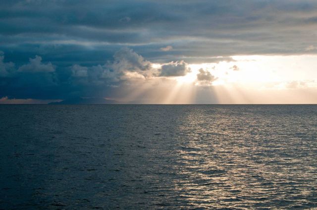 Crepuscular rays streaming through the clouds in the Channel Islands. Picture