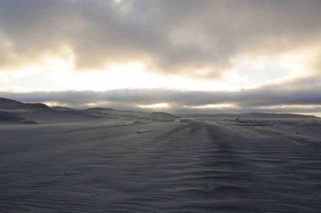 Sunbeams peaking through a hole in the clouds and over a lonely beach on Santa Rosa Island Picture