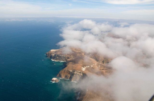 Santa Cruz Island with low clouds seen from an aerial view. Picture
