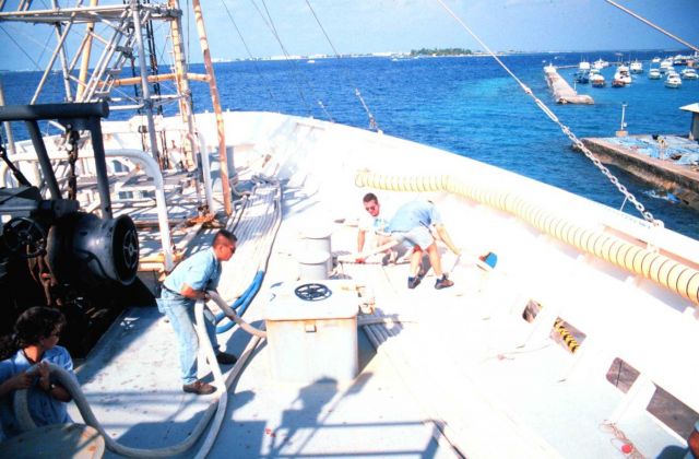 Crewmembers Pat Quinanola, Matt Ofsthus, and Terry Gregg help tie up the RONALD H Picture