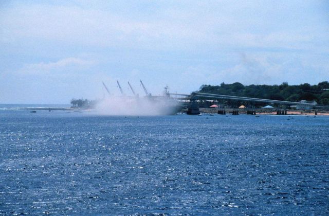 A view of filling a bulk carrier ship with phosphate at the piers at Nauru as seen from the NOAA Ship RONALD H Picture