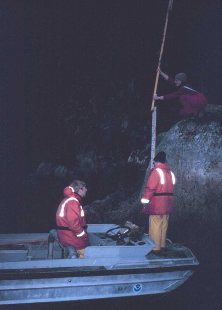 Survey Tech Sandy Zirnheld and Ensign Angie Venturato leveling the tide staff Ordinary Seaman Chip Miller looks on. Picture