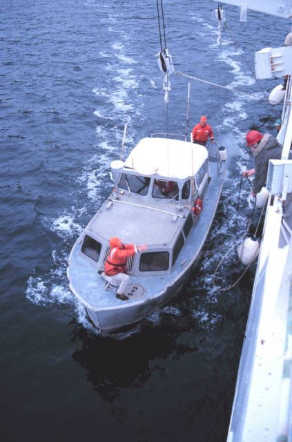 RA-1 boat pulls alongside the RAINIER prior to being hoisted out of the water. Picture