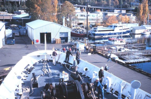 Chief Boatswain Jim Kruger (in green hard hat) directs RAINIER Deck Department personnel as the RAINIER returns home to Seattle and its base at the Pa Picture