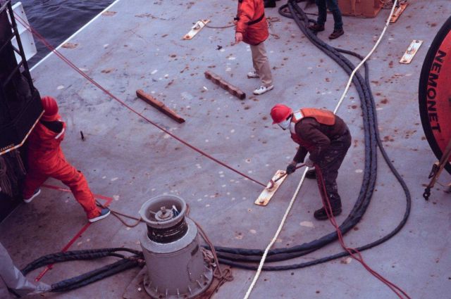 Deck personnel controlling an oceanographic buoy as it is deployed from the NOAA Ship RONALD H Picture
