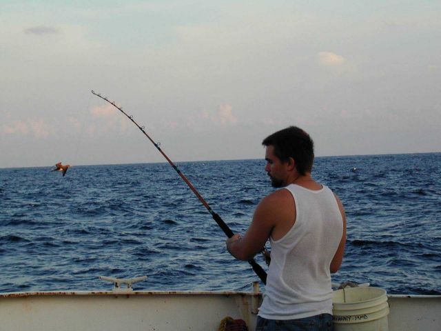 McARTHUR deck hand Michael Theberge fishing during free time in the Eastern Tropical Pacific. Picture