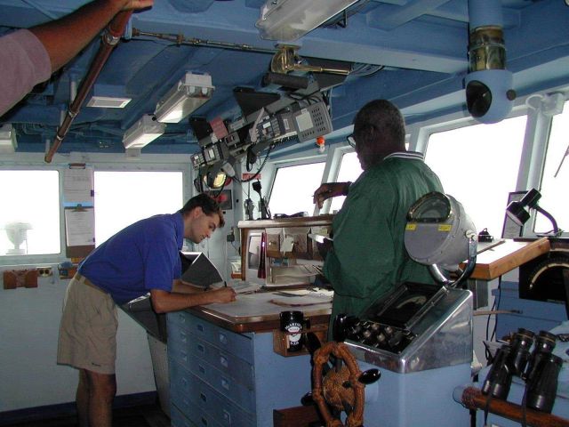 NOAA Corps Ensign Doug Krause and Seaman Surveyor Leroy Johnson on bridge wing of NOAA Ship McARTHUR. Picture