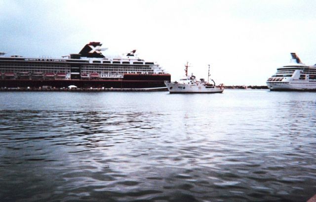 The McARTHUR dwarfed by cruise ships as it enters Key West Harbor. Picture