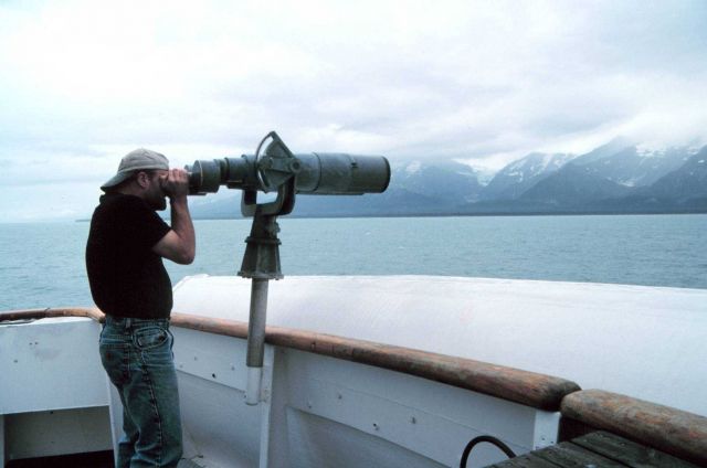 Marine mammal observer looking through the 