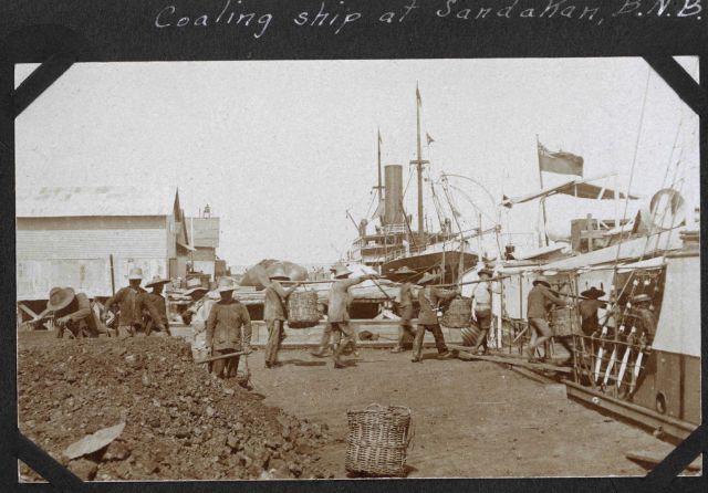 Coaling ship at Sandakan, Borneo. Picture