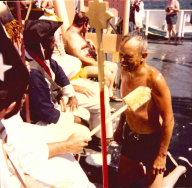 Monte Poindexter receiving being dubbed by the royal sceptre during Equator crossing ceremonies on the ESSA Ship DISCOVERER. Picture