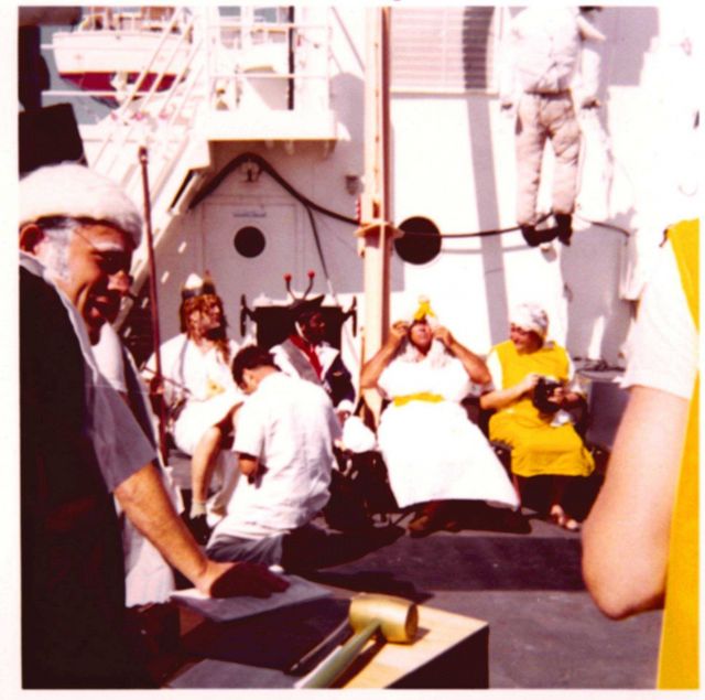 A properly respectful pollywog bowing before King Neptune during Equator crossing ceremonies on the ESSA Ship DISCOVERER. Picture