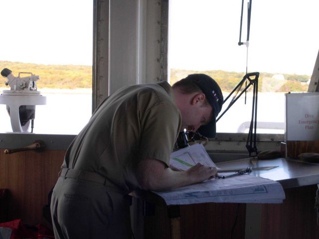 Ensign Salisbury checking his position on the paper chart. Picture