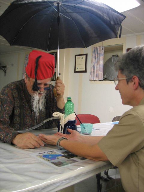 Captain Emily Christman has her fortune read on Halloween by NOAA Ship THOMAS JEFFERSON soothsayer. Picture
