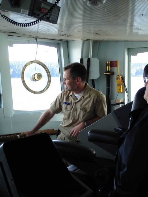 Commander Guy Noll, commanding officer of the NOAA Ship RAINIER, maintaining watch as the RAINIER traverses constrained waters in Alaska. Picture