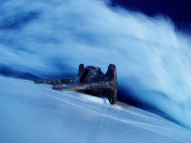 Looking over the anchor of the NOAA Ship HI'IALAKAI as spray flies off the bow while the ship is underway. Picture