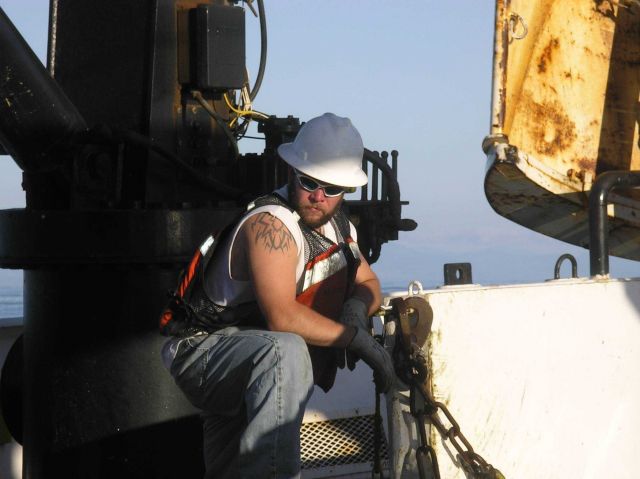 Kris Mackie checking fastenings on the back deck of the Miller Freeman during the 2005 NWFSC Acoustic Hake Survey. Picture
