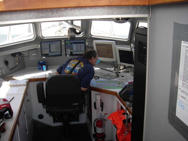 Peter Liewit, Senior Survey Tech, on NOAA Ship THOMAS JEFFERSON, conducting survey operations during launch hydro. Picture