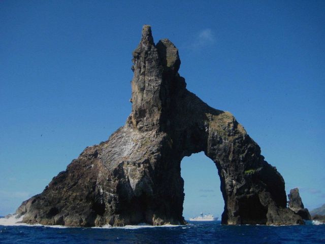 NOAA Ship HI'IALAKAI seen offshore through natural arch at Pagan Island. Picture