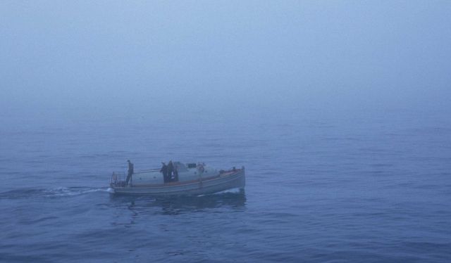 Launch from USC&GS Ship PATHFINDER towing native umiak, a skin-covered boat larger than the one or two man kayaks. Picture