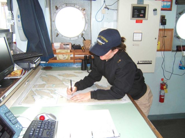 Writing up the log on the NOAA Ship MILLER FREEMAN. Picture