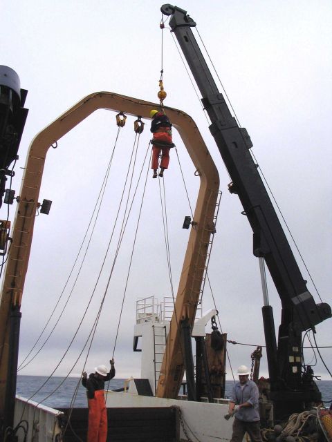 Performing maintenance on the running gear of the A-frame on the NOAA Ship MILLER FREEMAN. Picture