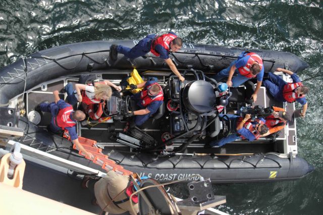 United States Coast Guard rigid-hull inflatable boat discharging personnel on NOAA Ship PISCES. Picture