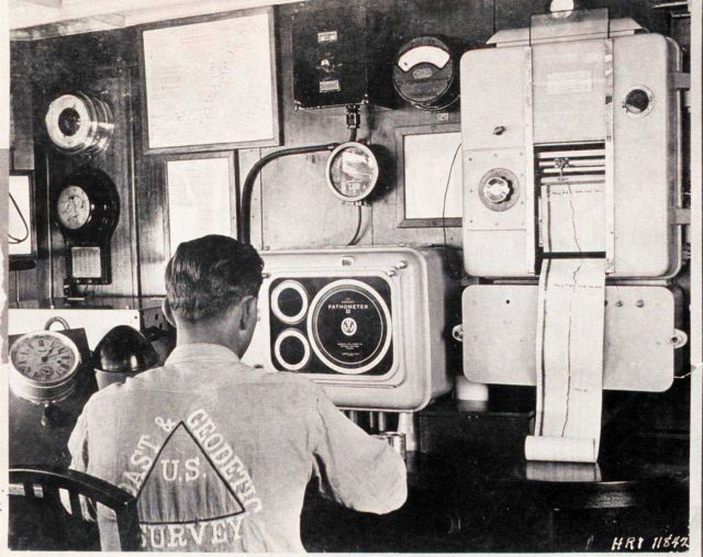 A crewman operates a light-registering fathometer while wearing a home-designed U Picture