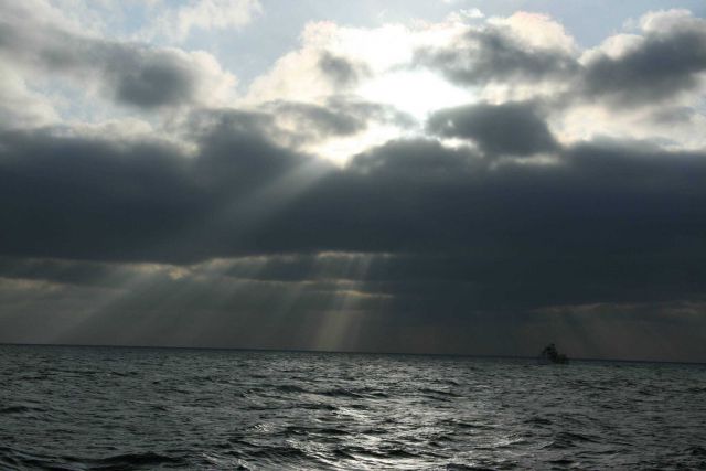NOAA Ship OSCAR DYSON seen in the crepuscular rays of a late afternoon sun. Picture