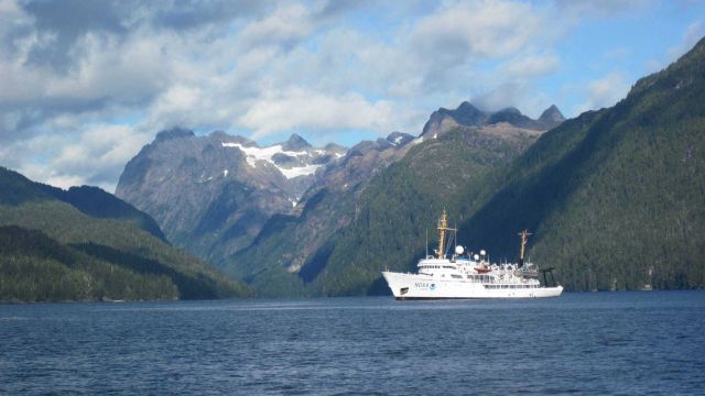 NOAA Ship FAIRWEATHER and the majestic peaks of Chatham Strait area. Picture