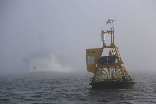 NOAA Ship FAIRWEATHER servicing weather buoy 46041 off the Washington coast between Aberdeen and Cape Flattery on a foggy summer day. Picture