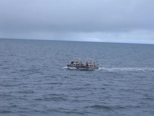 NOAA survey launch 2806 bringing broken-down launch 2808 back to ship. Picture