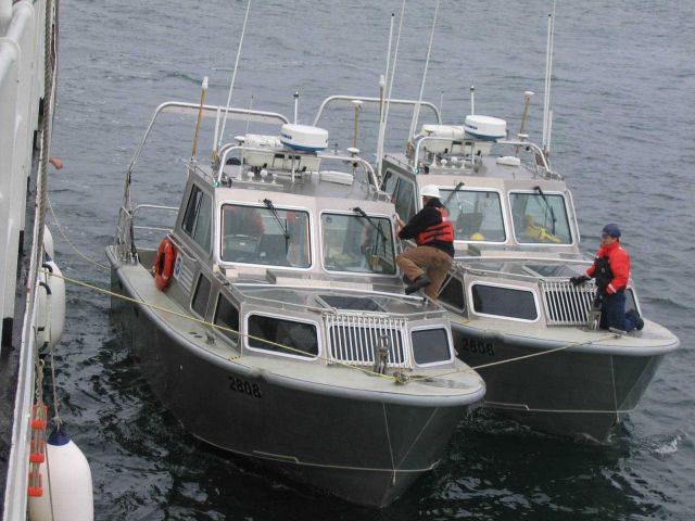 NOAA survey launch 2806 bringing broken-down launch 2808 back to ship. Picture