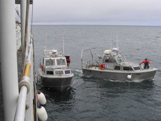 NOAA survey launch 2806 casting off from launch 2808 after successfully returning broken down Launch 2808 to ship. Picture
