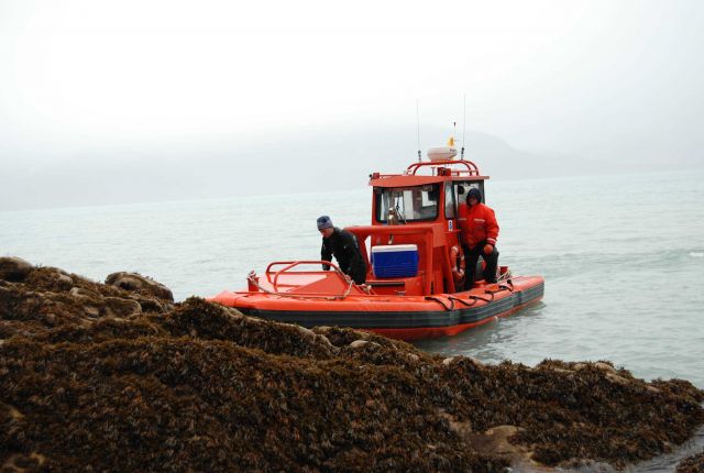 NOAA SHIP FAIRWEATHER RHIB transporting personnel to a rocky shoreline at low tide. Picture