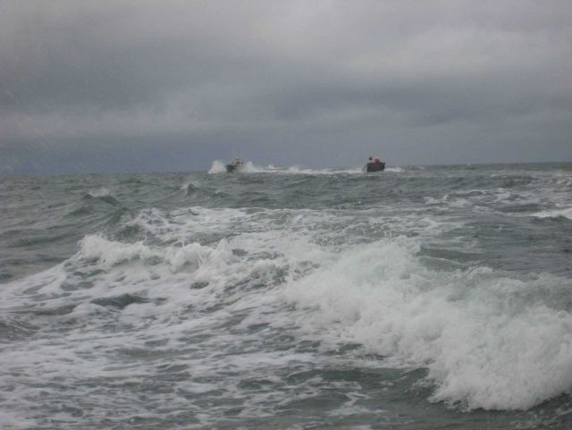 Three ship's boats going to work in the vicinity of Kotzebue. Picture