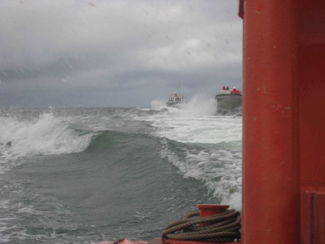Three ship's boats going to work in the vicinity of Kotzebue. Picture