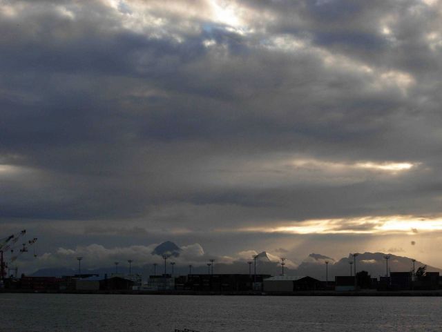 Papeete harbor seen at twilight looking towards the high peaks of Moorea. Picture