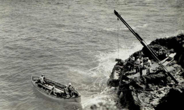 Offloading equipment on rocky shore Picture