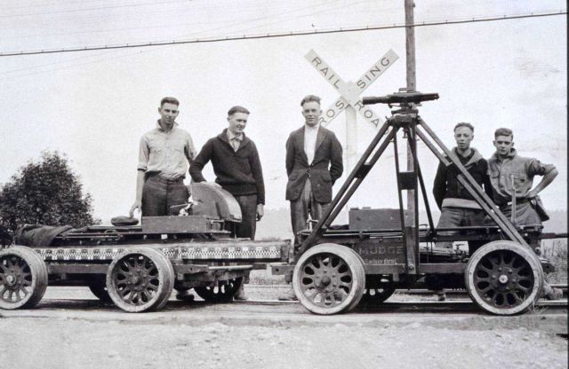 Leveling crew with inclined tripod mounted on velocipede Picture